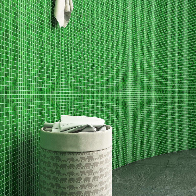 Green square mosaic tiles on the wall, paired with modern storage bins