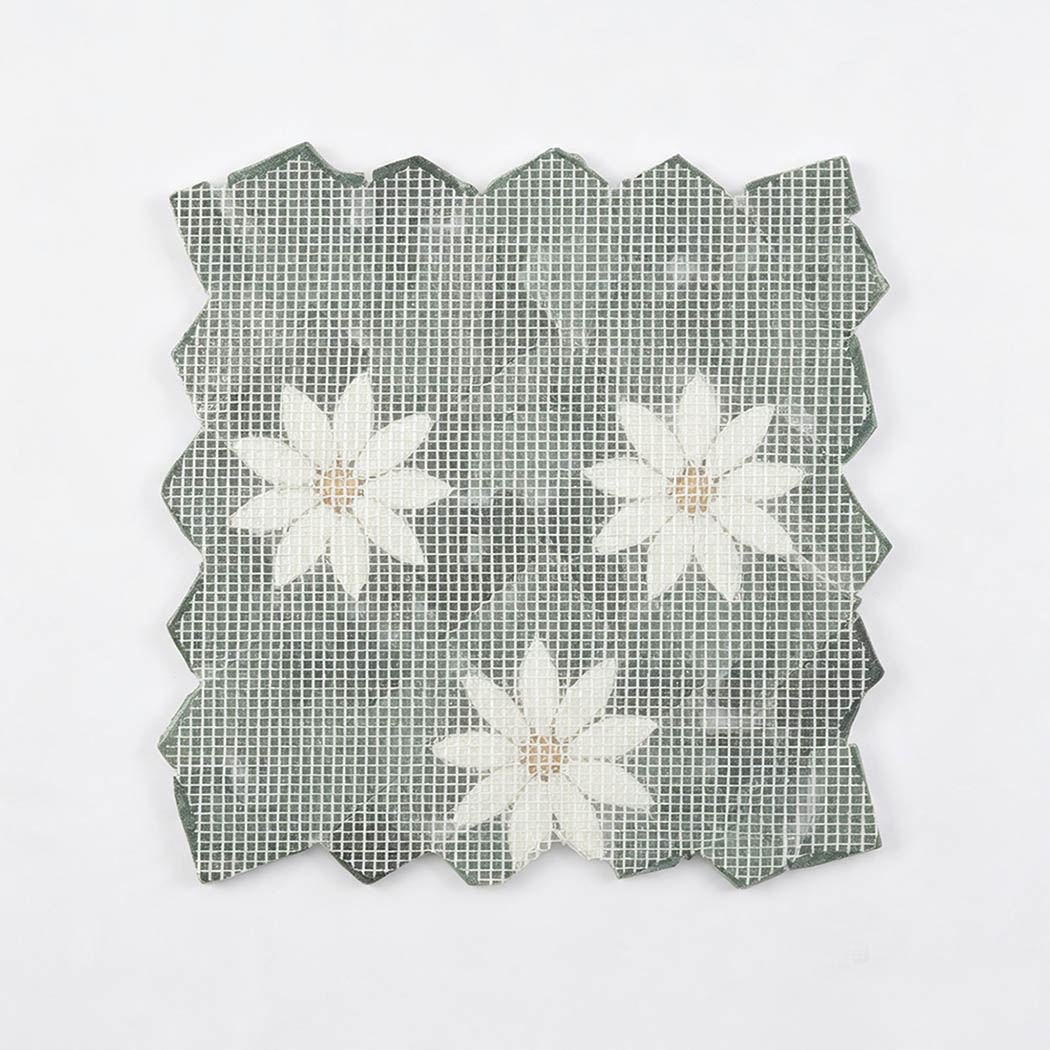 Mesh-backed reverse side of green and white floral marble mosaic tile