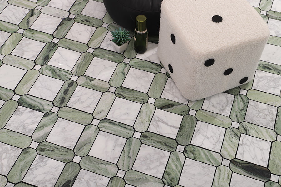 Patterned marble floor with green and white tiles beside a dice-shaped seat.