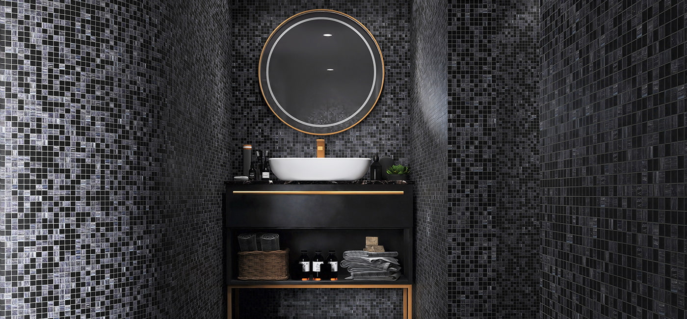 Grey black mosaic glass tile wall in modern bathroom vanity space