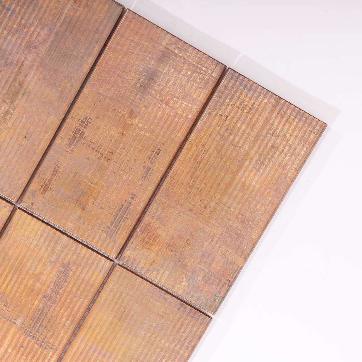 Close-up of vertical grooved texture on rustic copper tile