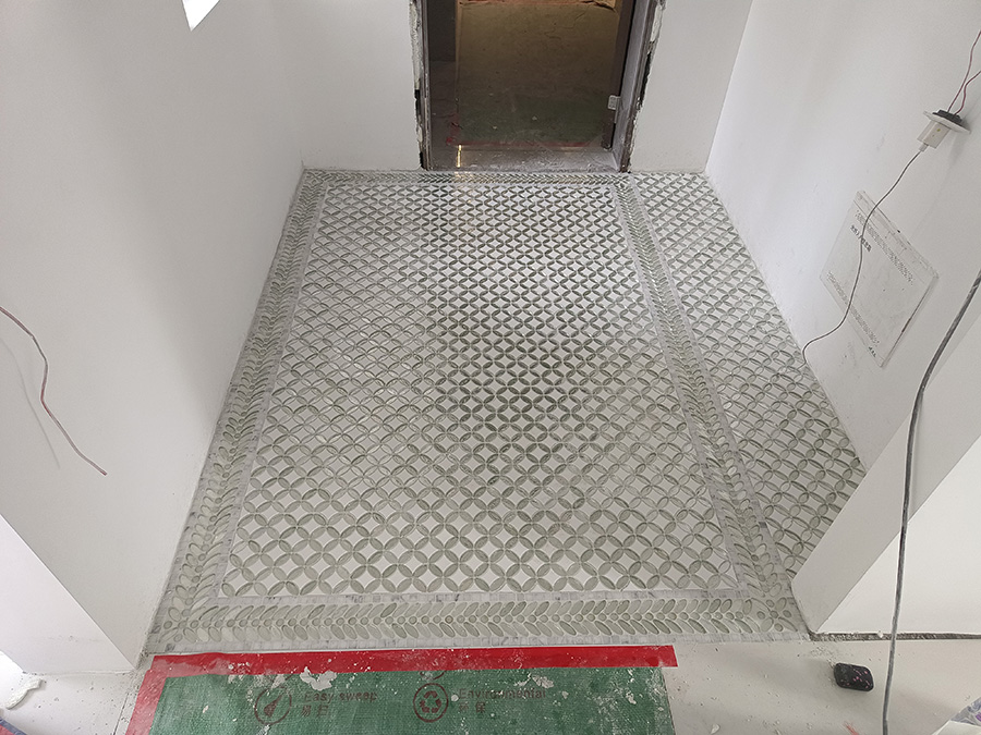 Hallway geometric mosaic floor installation