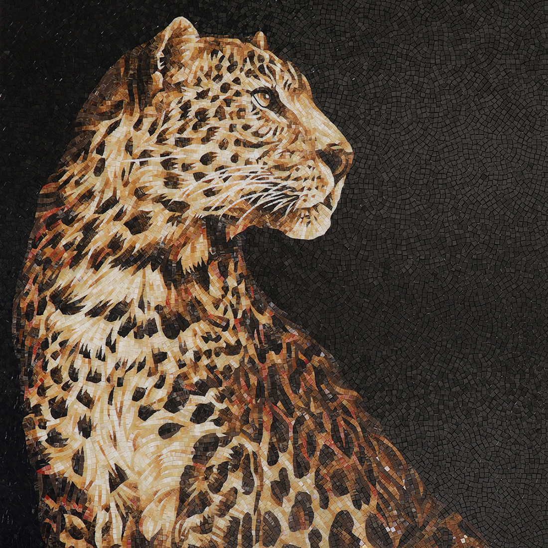 Handmade cheetah mosaic mural with warm brown spots on a black background