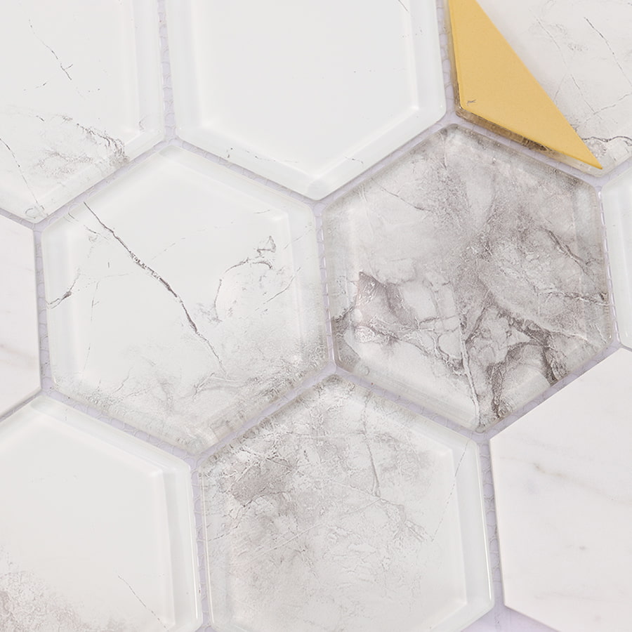 Close-up of marble texture and gold accent on hexagon mosaic tile.