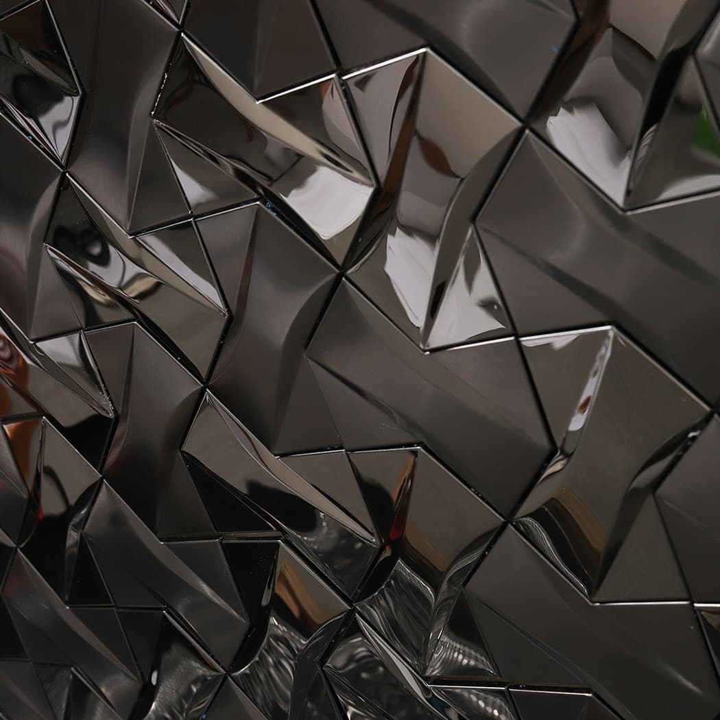 A large scale seamless pattern of black 3D geometric tiles creating a textured wall.