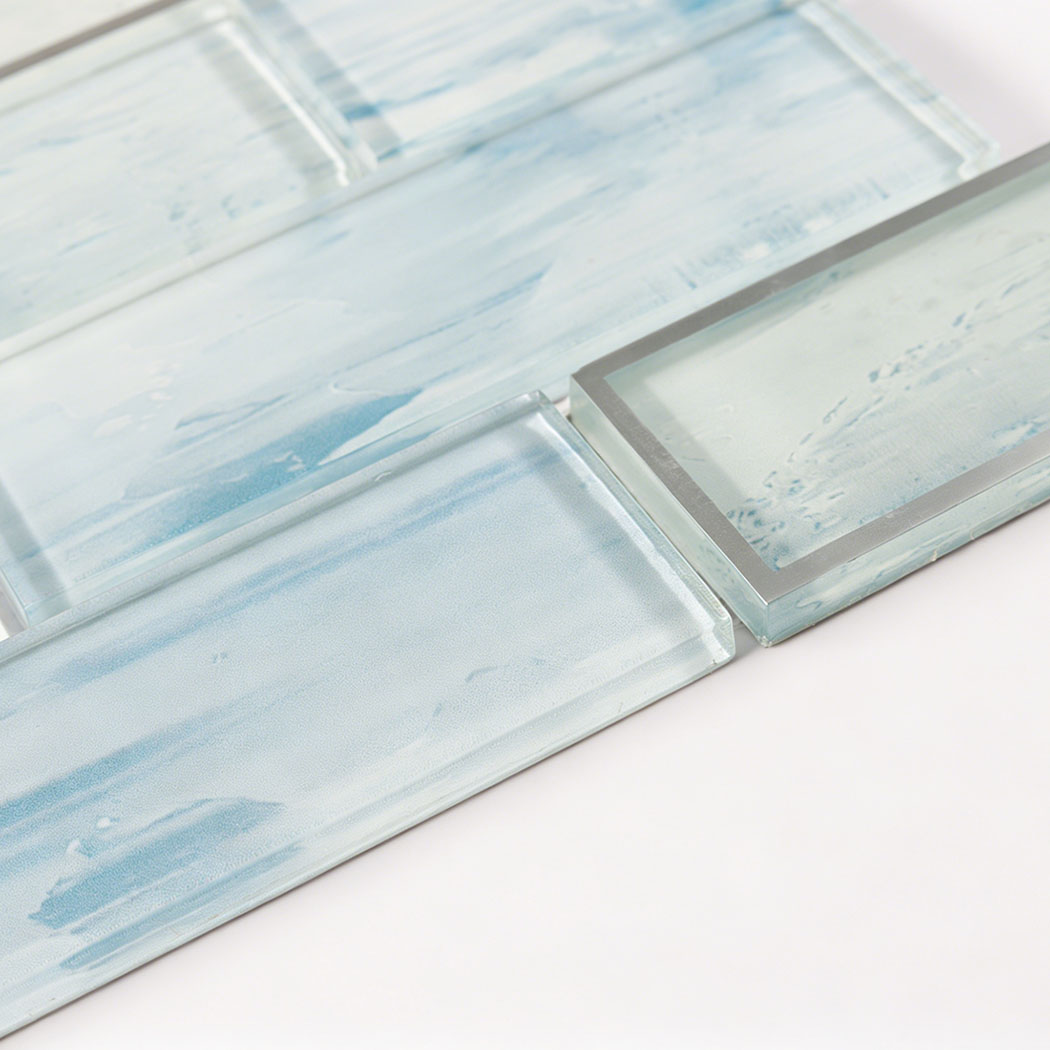 Ice blue glass subway tile surface with silver edge accent and smooth gloss