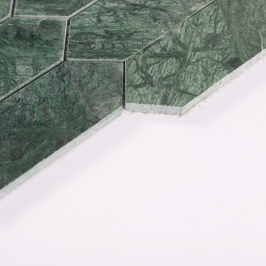 Edge detail of Indian green picket polished marble mosaic tile showing thickness.