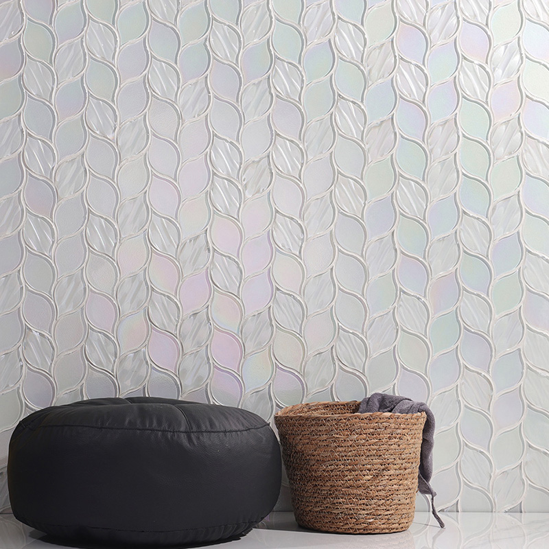 Decor wall with iridescent leaf tiles, black pouf, and wicker basket.