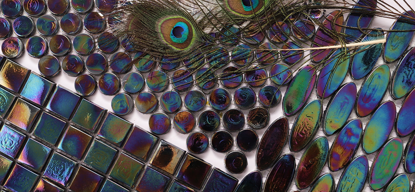Iridescent tiles arranged in a stunning peacock feather pattern, displaying vibrant colors.