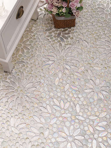 Iridescent petal-pattern mosaic floor tiles creating a shimmering effect