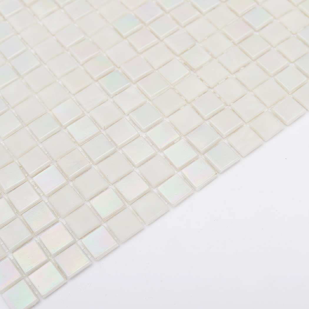 angled edge view of iridescent white glass mosaic tile sheet on white background