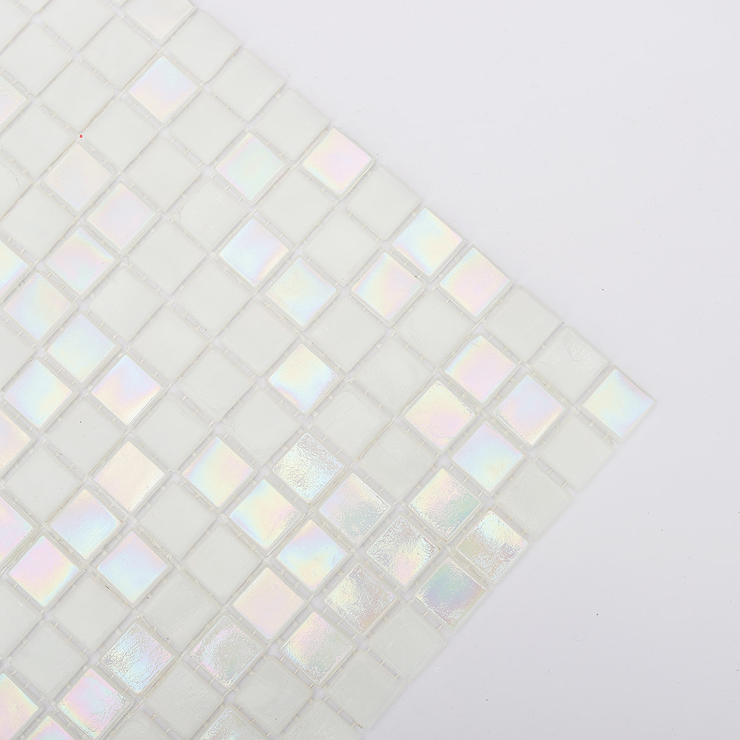 edge view of iridescent white square glass pool tiles showing reflective finish
