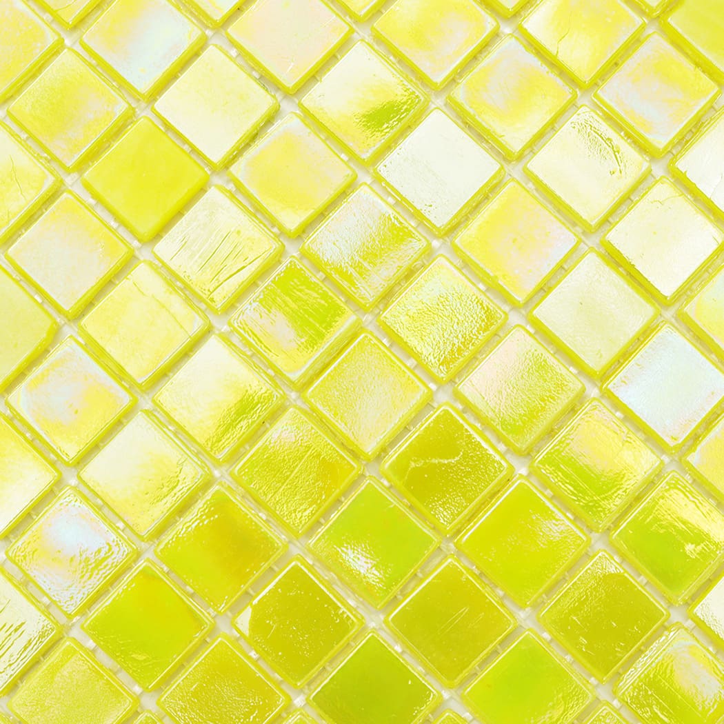 Extreme close up texture of iridescent yellow glass mosaic tiles highlighting reflections.