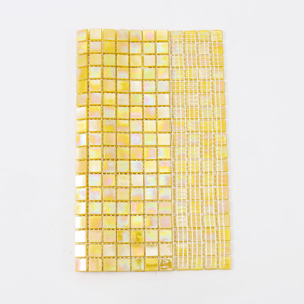 A folded yellow mosaic tile sheet showing the white mesh backing used for easy installation.