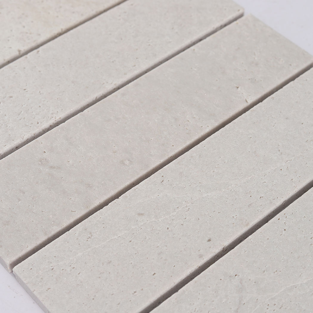 Detailed view of the lightly textured surface on ivory travertine mosaic strips