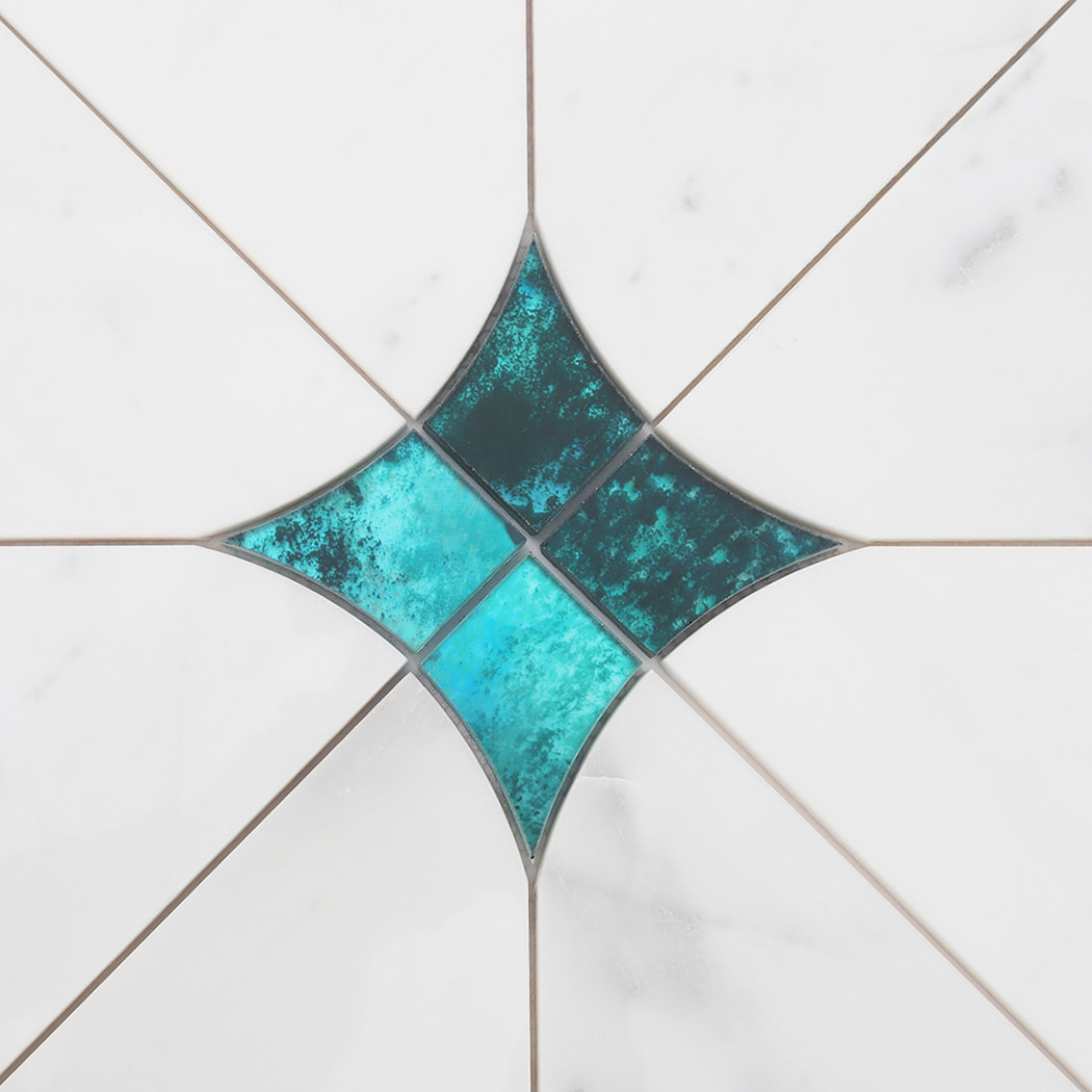 Close up of the center point where four tiles meet, creating a larger blue glass star pattern.