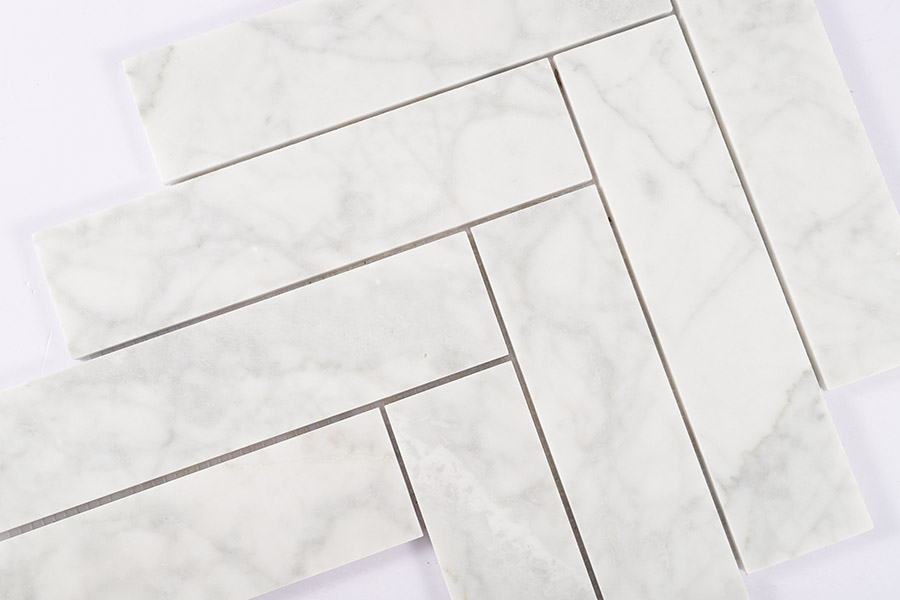 Professional layout of Large Herringbone Tiles in polished white marble for modern flooring.
