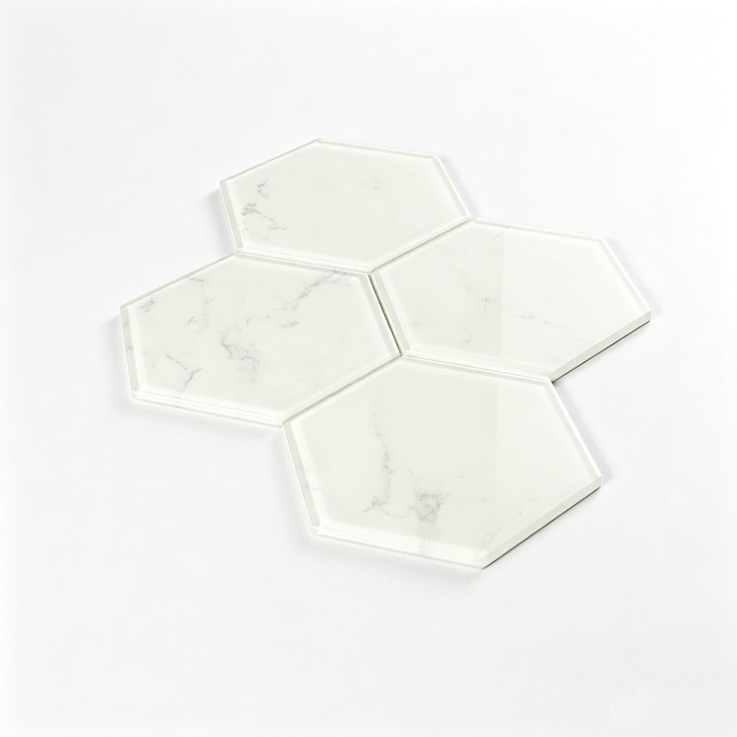 Angled display of large white marble look hexagon glass tile sample