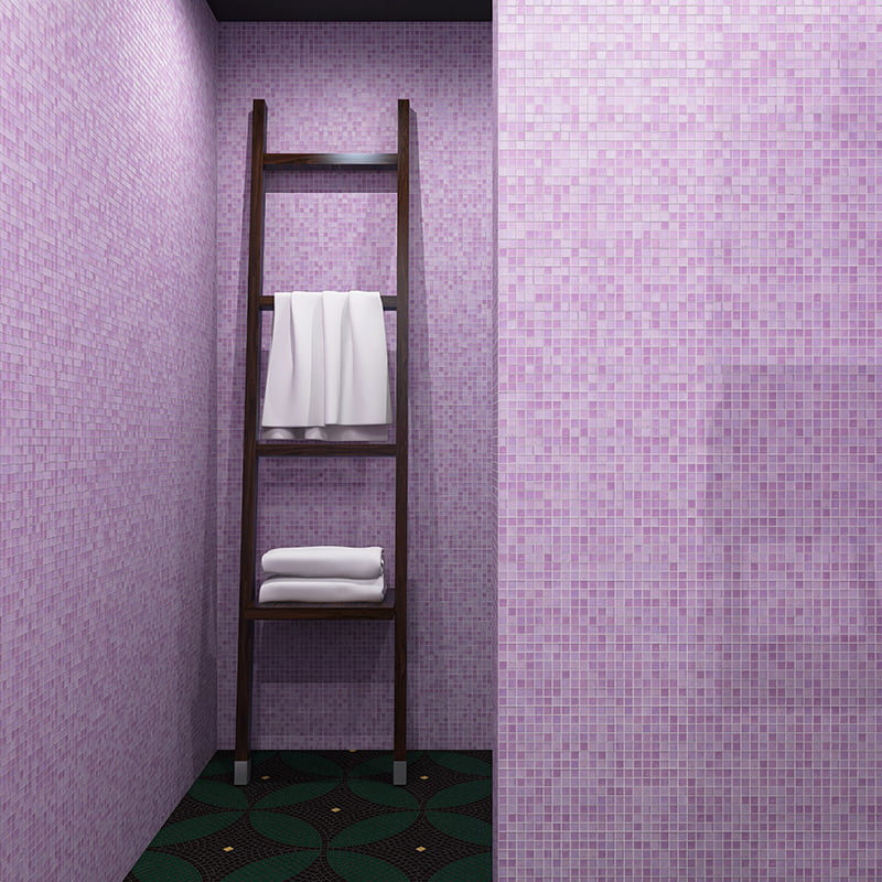 Wooden leaning towel ladder placed against a lavender glass mosaic tile wall