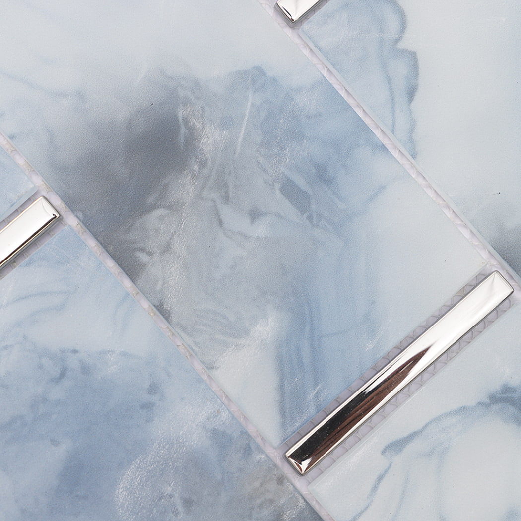 Close-up of light blue marble look glass subway mosaic tiles and silver accents