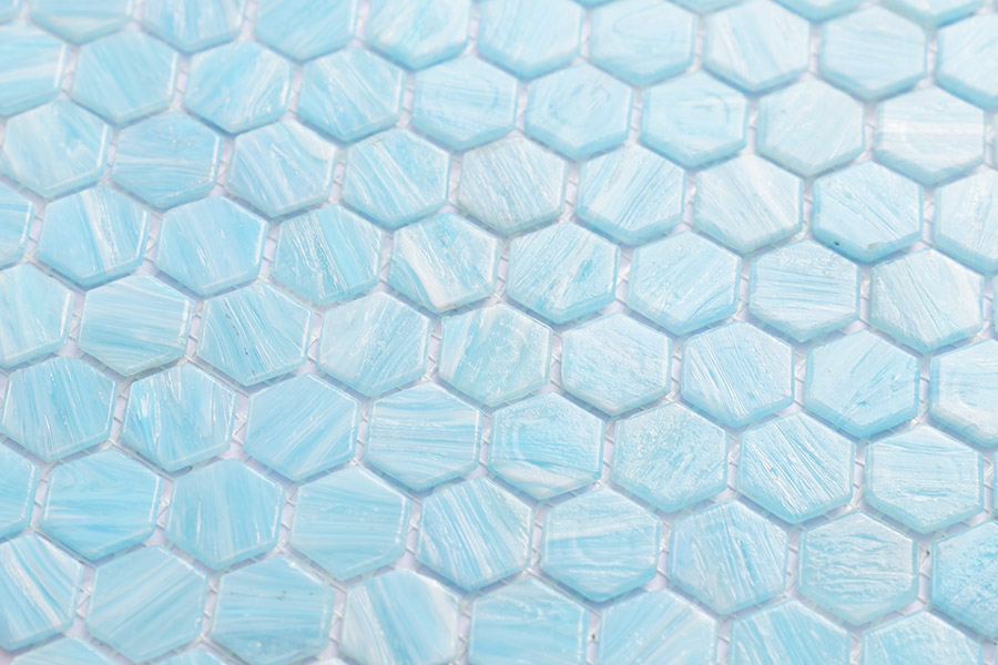 Light blue hexagon glass mosaic tiles with subtle texture, close-up view