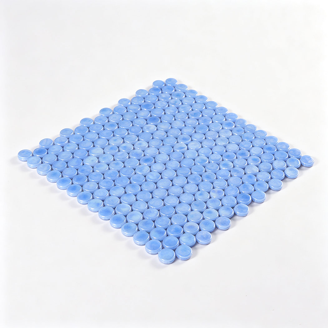 Angled view of a light blue iridescent round glass mosaic tile sheet