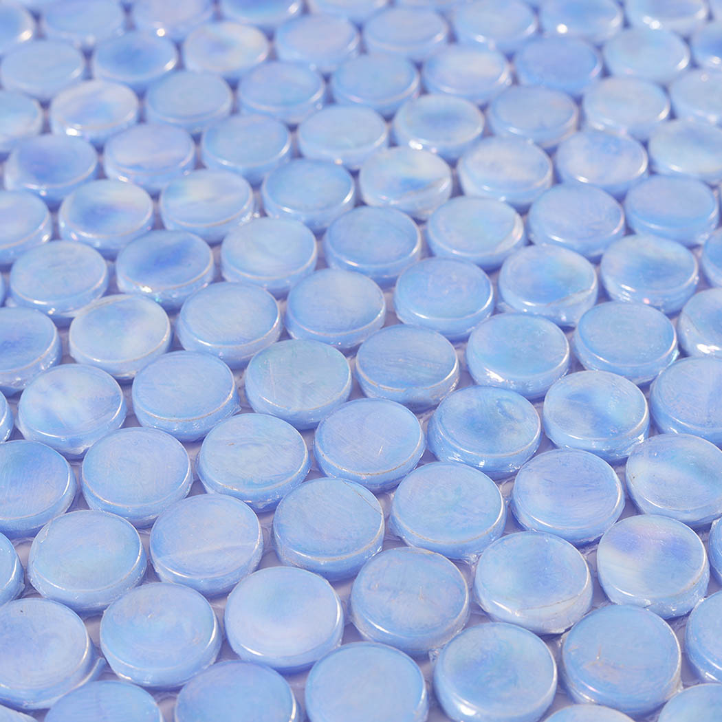 Surface close-up of light blue iridescent round glass mosaic tiles