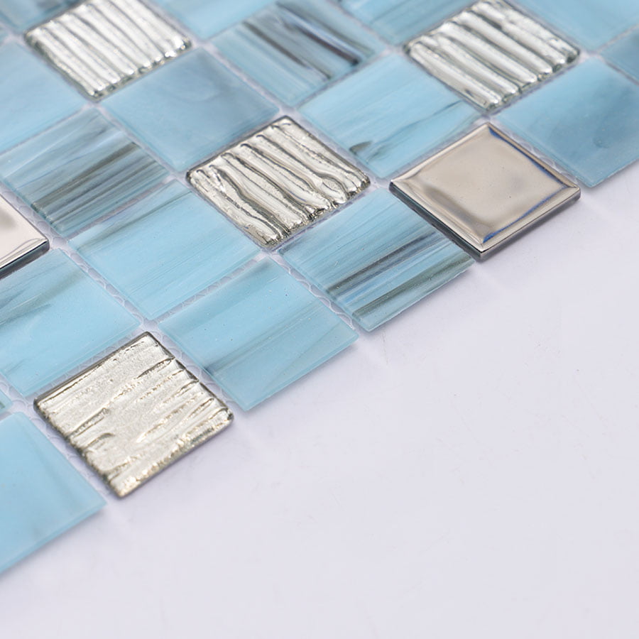 Angled view of light blue mosaic tile sheet with metallic accents