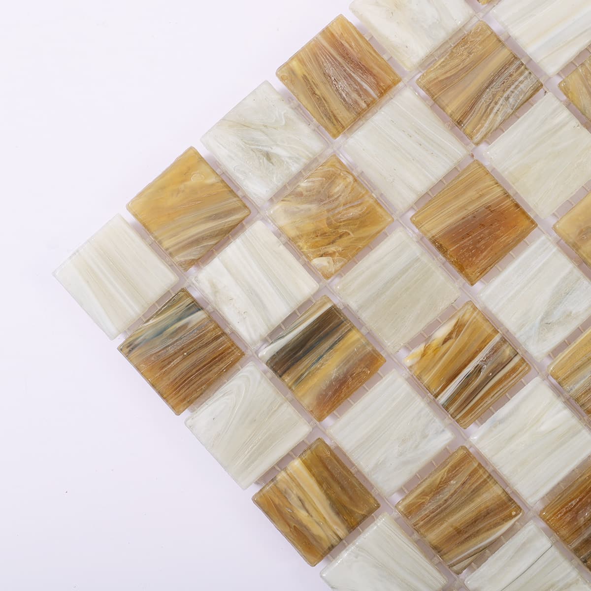 Corner close-up of light brown and beige checkered glass mosaic tiles