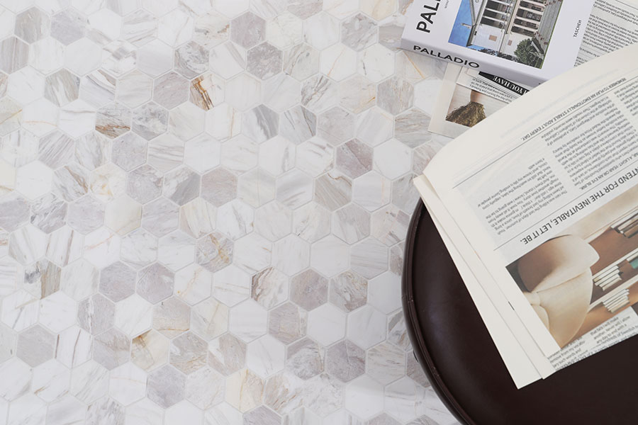 Light gray marble hexagon floor tile with books and black side table