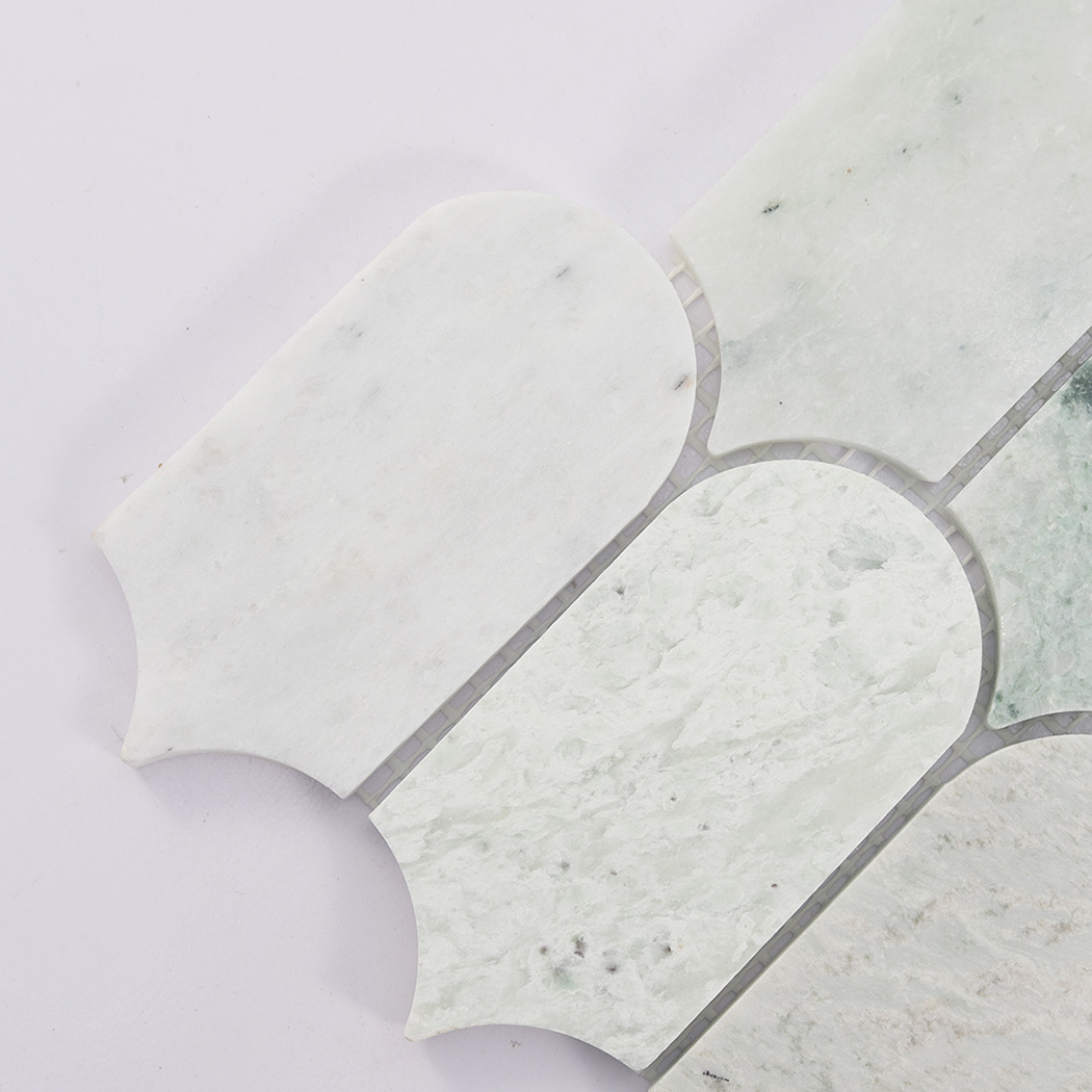 Corner detail of light green arched marble mosaic tile with natural veining