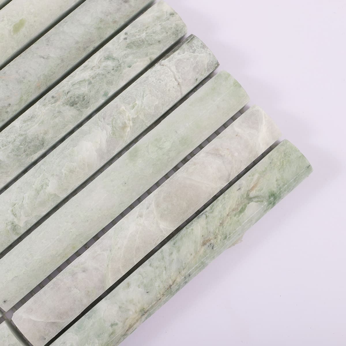 Close-up showing edge detail of fluted green marble tile