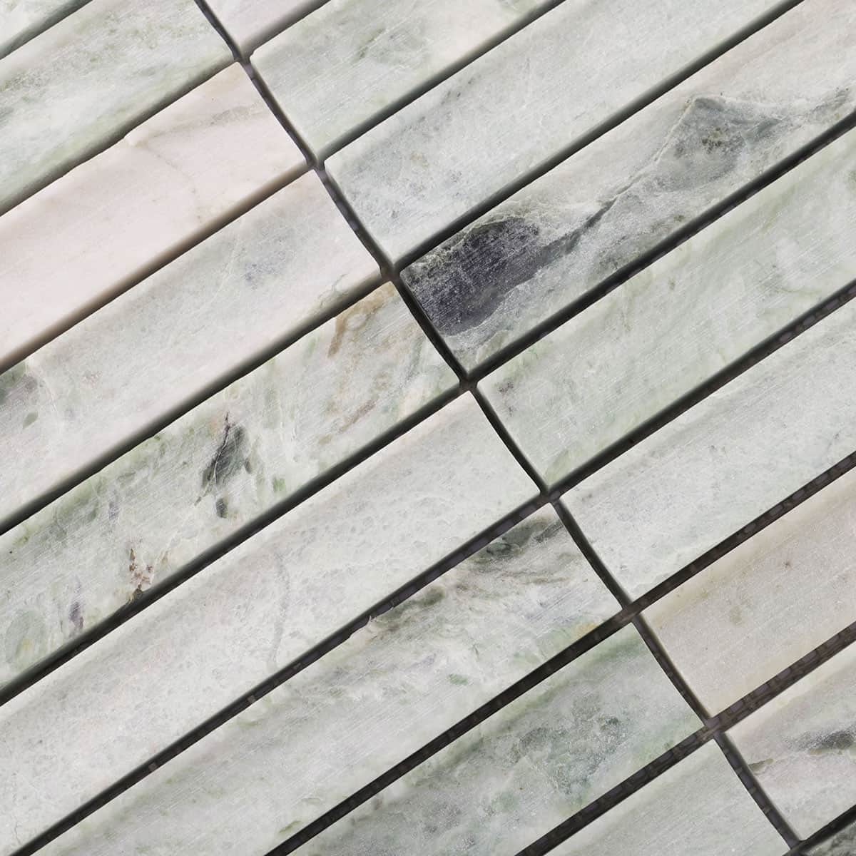 Angled layout of light green fluted marble stick tiles