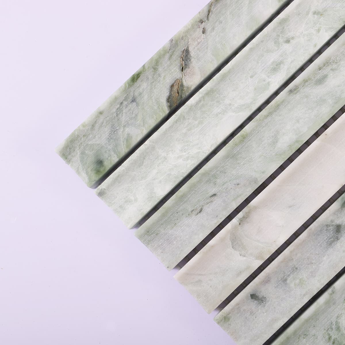 Corner close-up of light green fluted marble mosaic