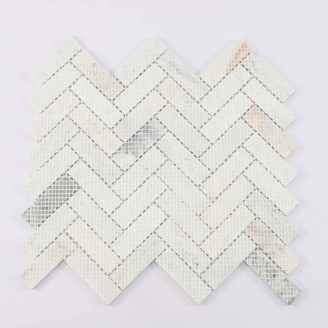 Back view of light green herringbone marble mosaic tile with mesh backing