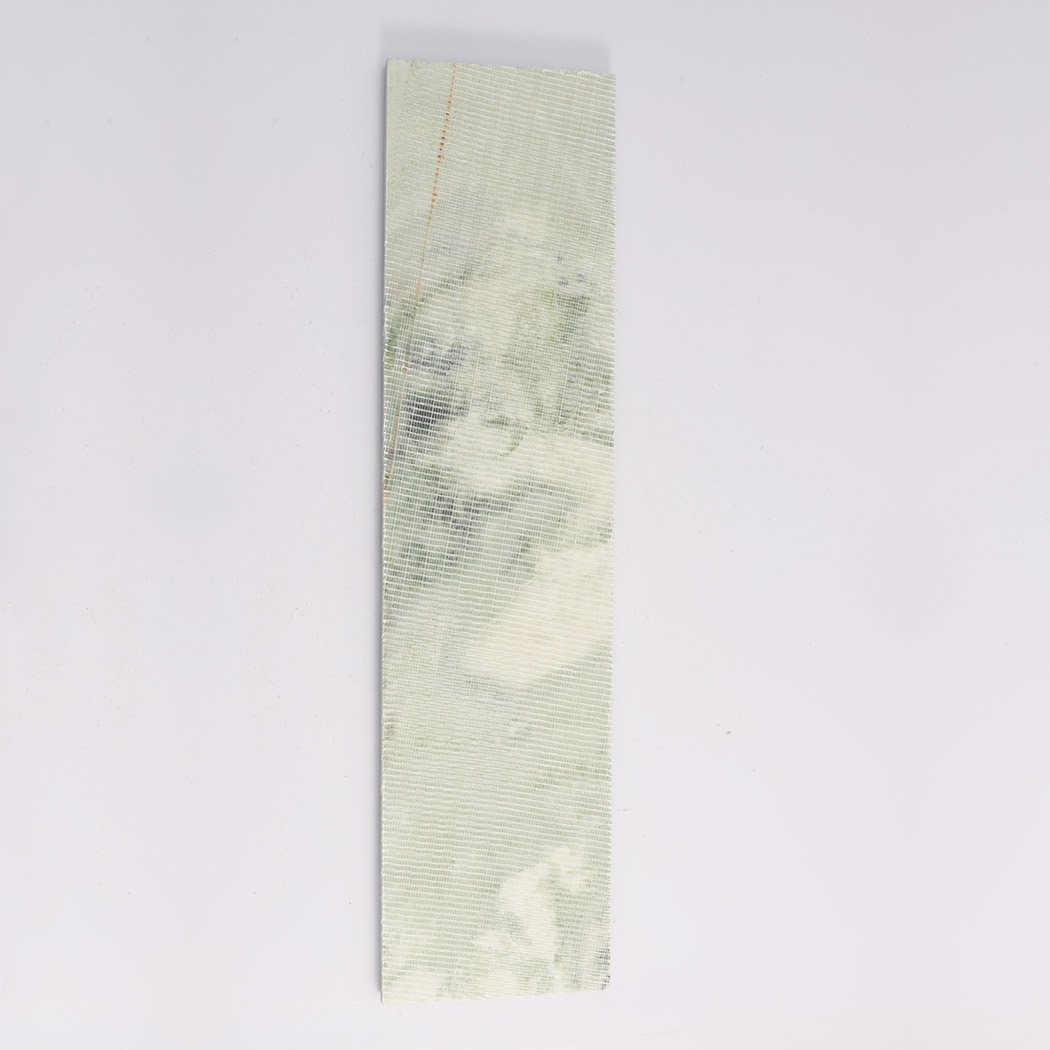 Back view of light green marble fluted tile with mesh textured backing