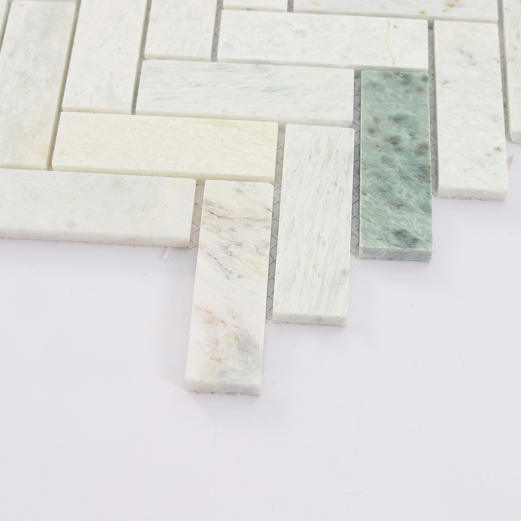 Side close up of light green herringbone marble mosaic tile showing thickness