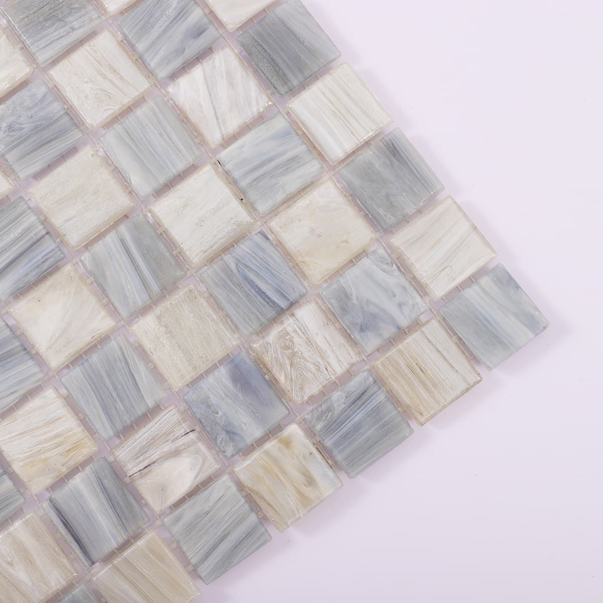 Close-up corner view of checkered glass mosaic in grey and blue