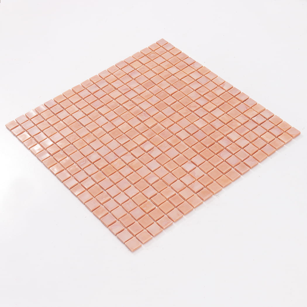 Angled view of a full light peach square glass mosaic tile sheet