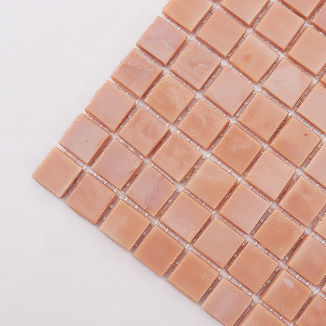 Corner close-up of light peach square glass mosaic tile with glossy finish