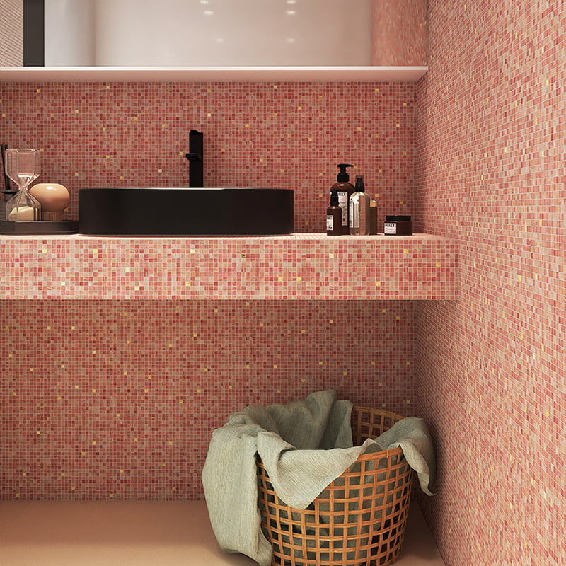 Bathroom sink and countertop clad in light pink glass mosaic tiles with matte, iridescent finishes 