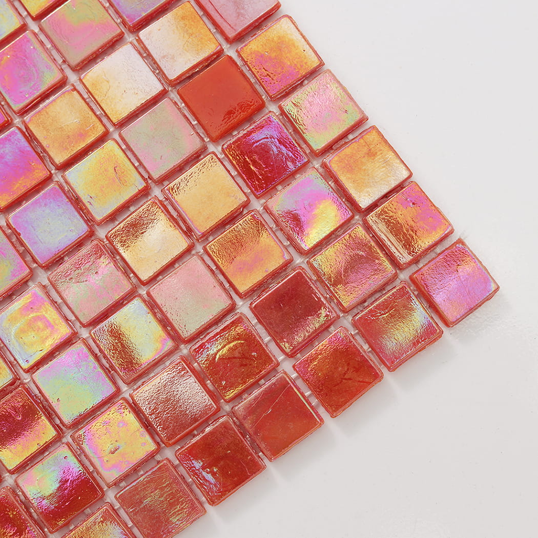 Corner close-up of light red iridescent square glass mosaic tile with glossy finish