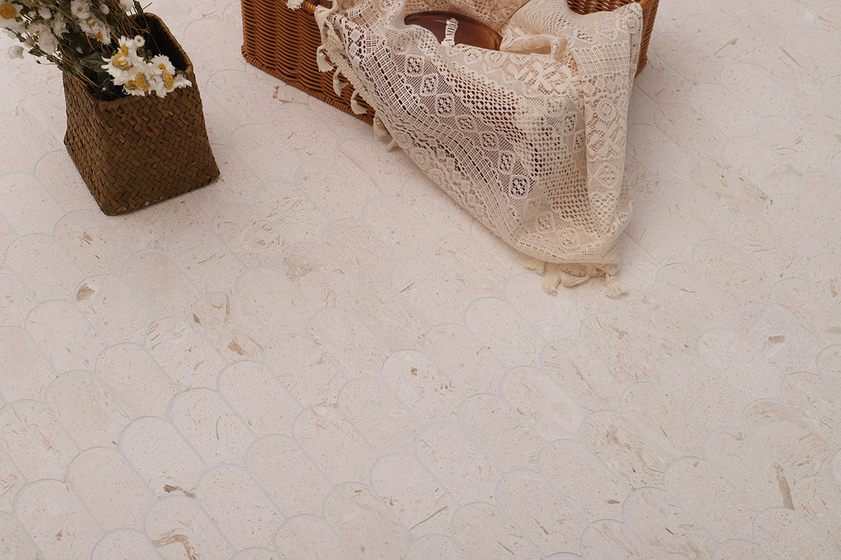 Cream limestone mosaic tiles in a scallop pattern with wicker baskets and flowers