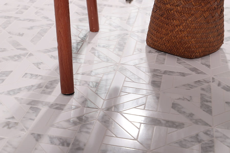 Marble floor tiles with geometric design under wooden chair and woven basket