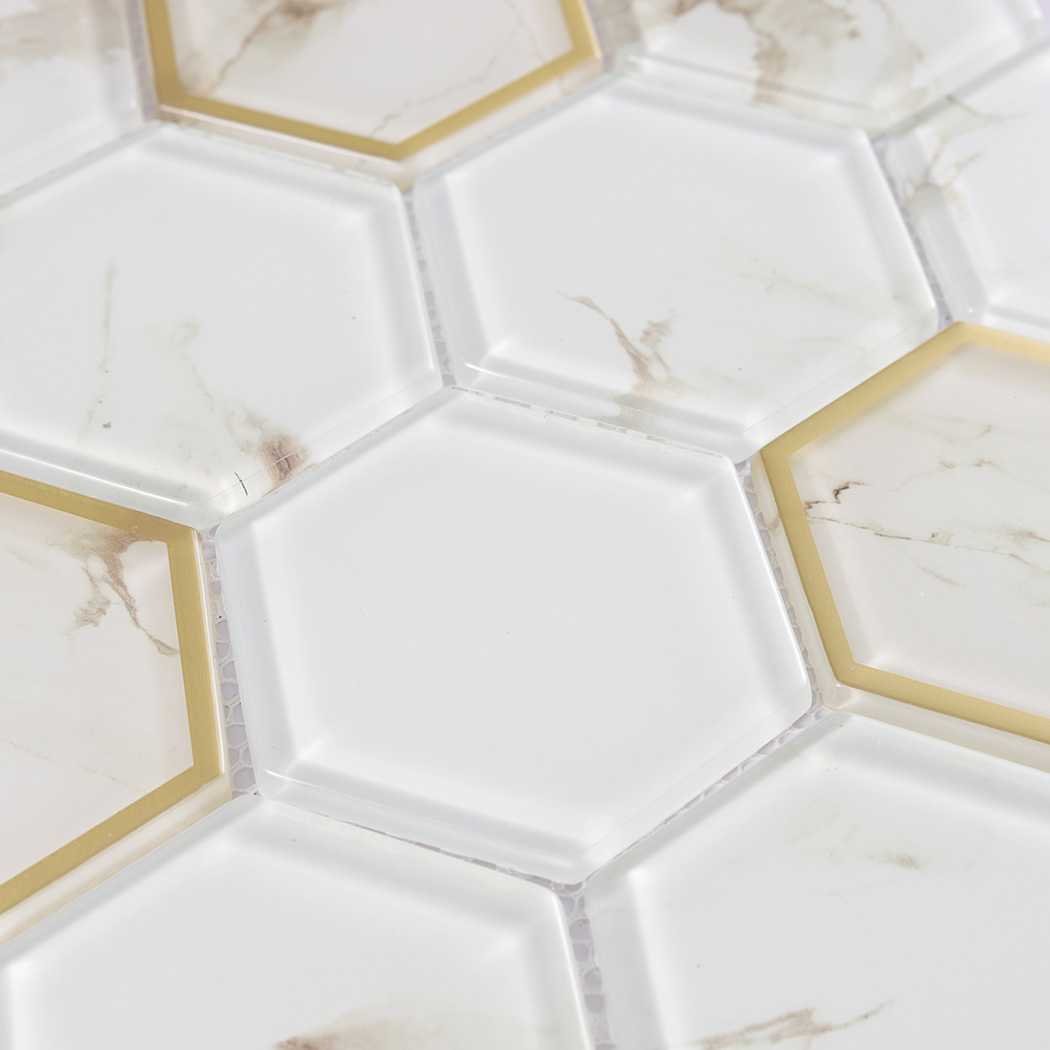 Macro view of white marble look hexagon glass tiles with gold glass accents