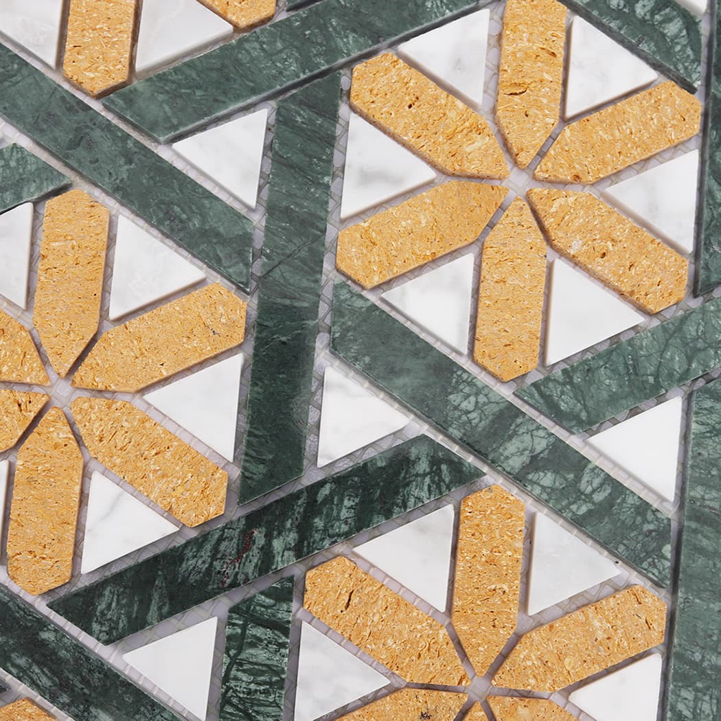 Close up showing the intricate yellow star and white triangle marble mosaic pattern.
