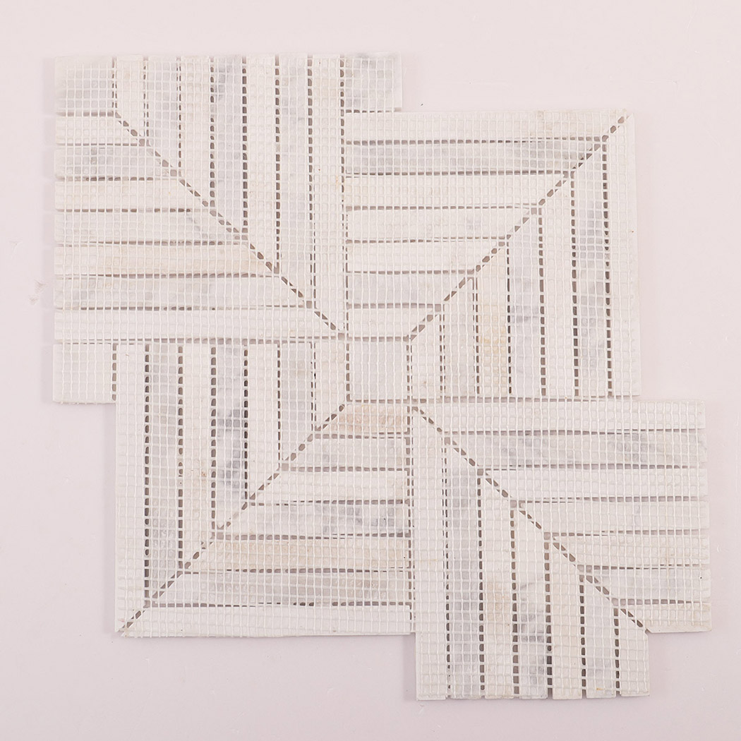 Rear view of a marble mosaic tile sheet showing the white mesh backing.