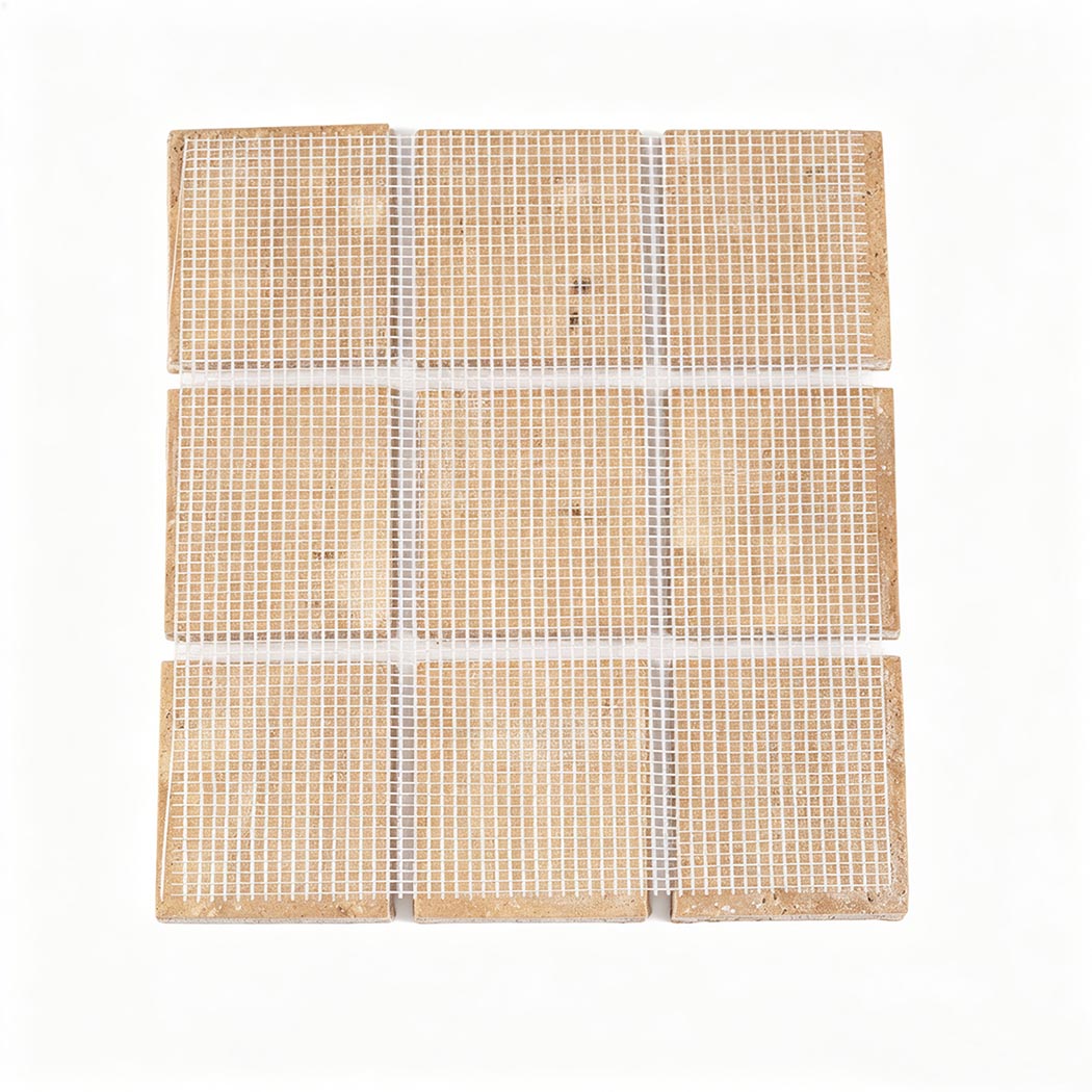 Back view of a beige square marble mosaic sheet with white mesh backing