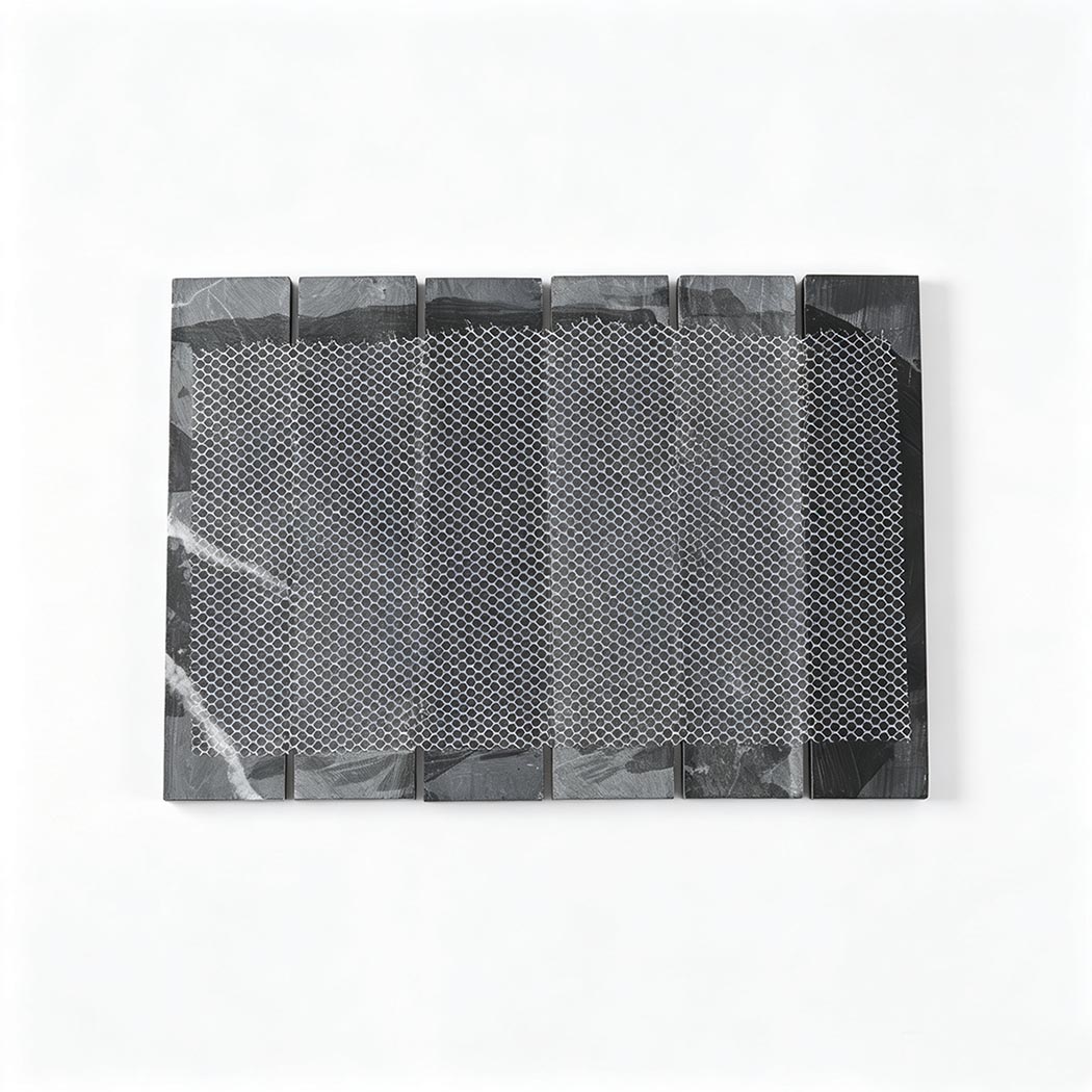 Back view of a black marble strip mosaic tile with flexible mesh backing