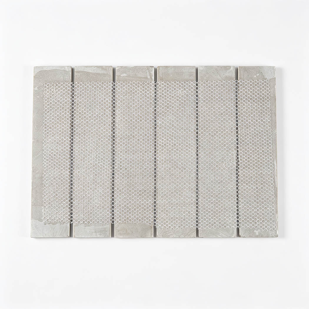 Back view of a light gray marble strip mosaic tile with flexible mesh backing